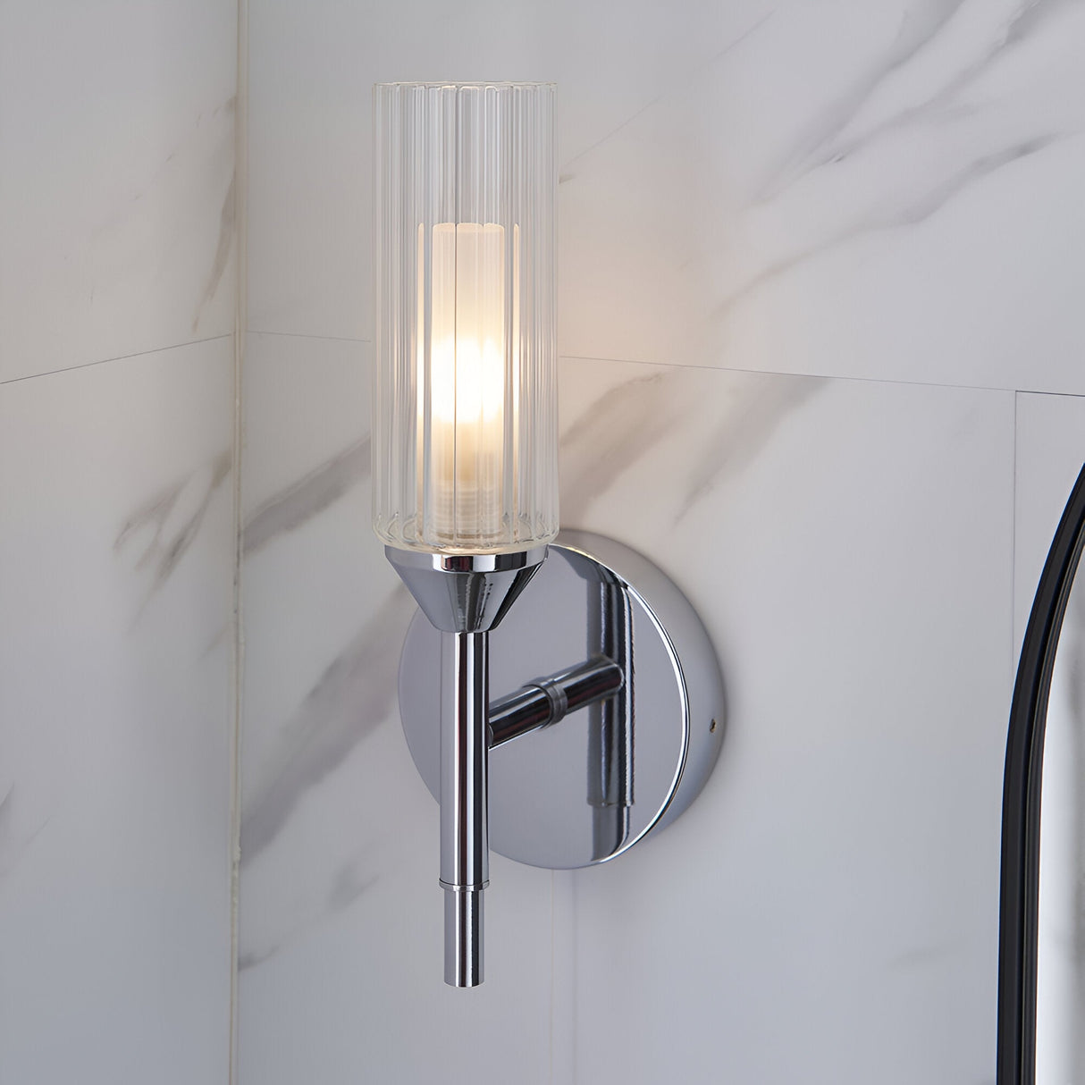 Endon Castbourne bathroom wall light in polished chrome with an upright ribbed glass torch shade and circular back plate, mounted on a marble wall.