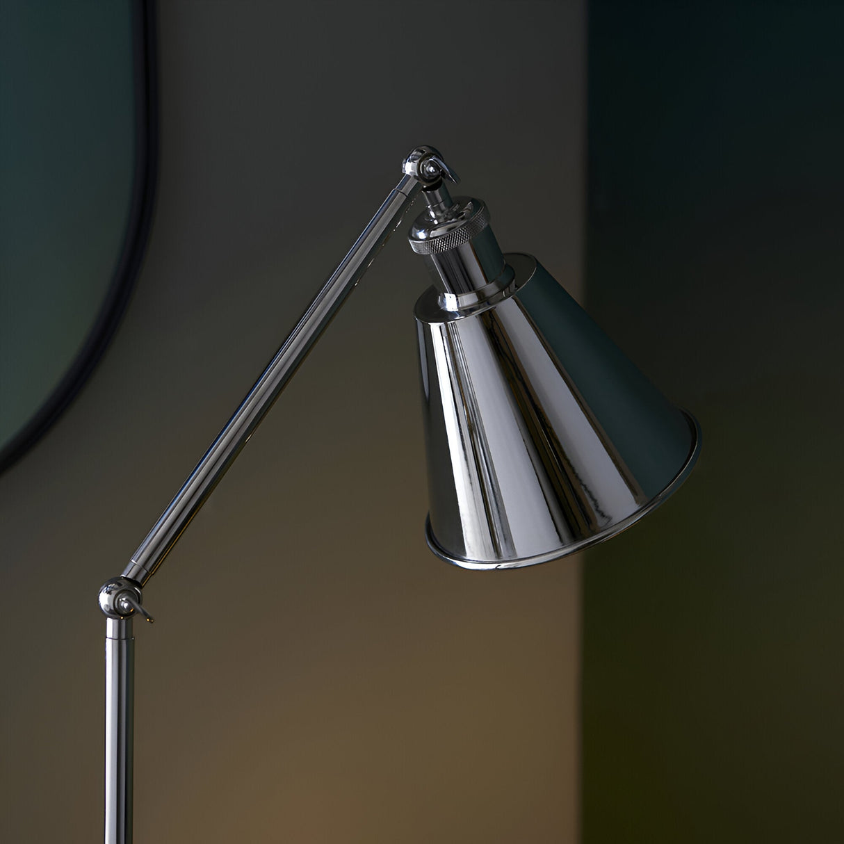 Close-up of Endon Brackley floor lamp head in bright nickel with knurled detailing, adjustable arm and conical shade against a dark backdrop.