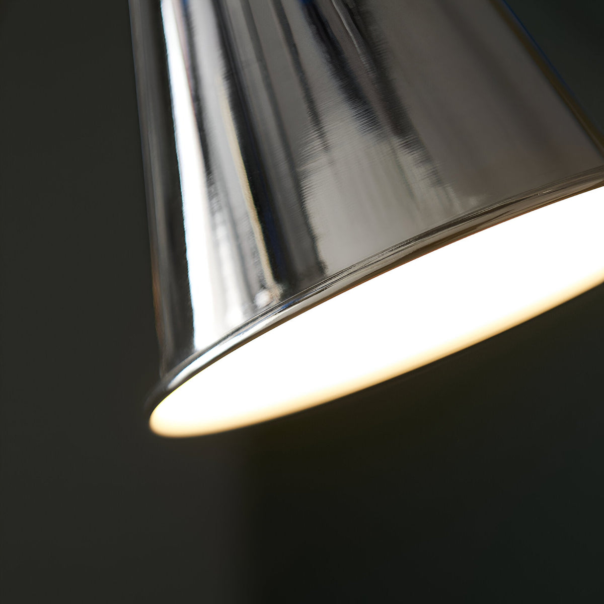 Close-up of the Endon Brackley floor lamp's nickel shade, showing the polished finish and satin white painted interior diffusing warm light.