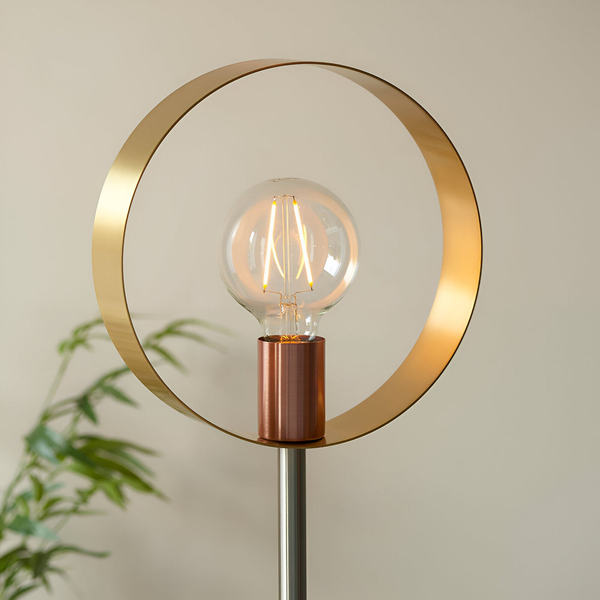 Brenmere Floor Lamp with brushed brass open hoop frame, copper bulb holder and nickel stem, holding an exposed E27 filament bulb against a neutral background.