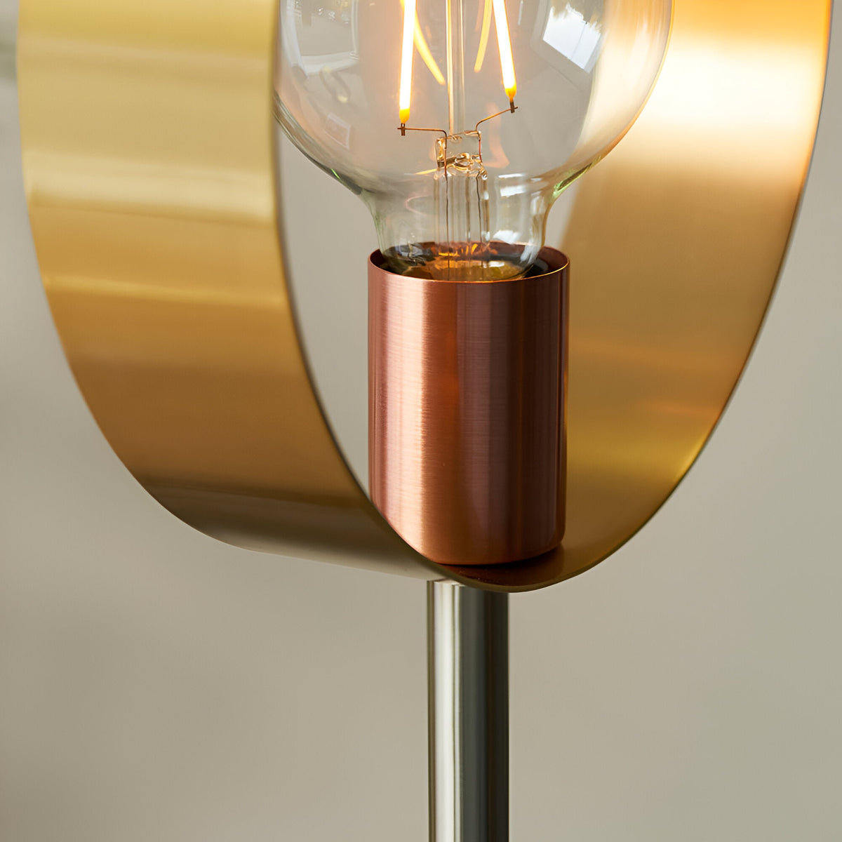 Brenmere Floor Lamp close-up showing an open brass hoop frame, exposed E27 filament bulb, and brushed copper lampholder on a nickel stem.