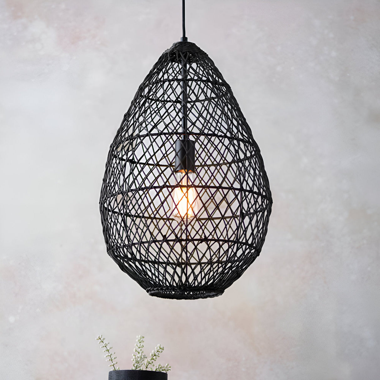 Endon Chartdale pendant light with a teardrop-shaped open-weave black rattan shade and single E27 Edison bulb, hung against a soft neutral background.