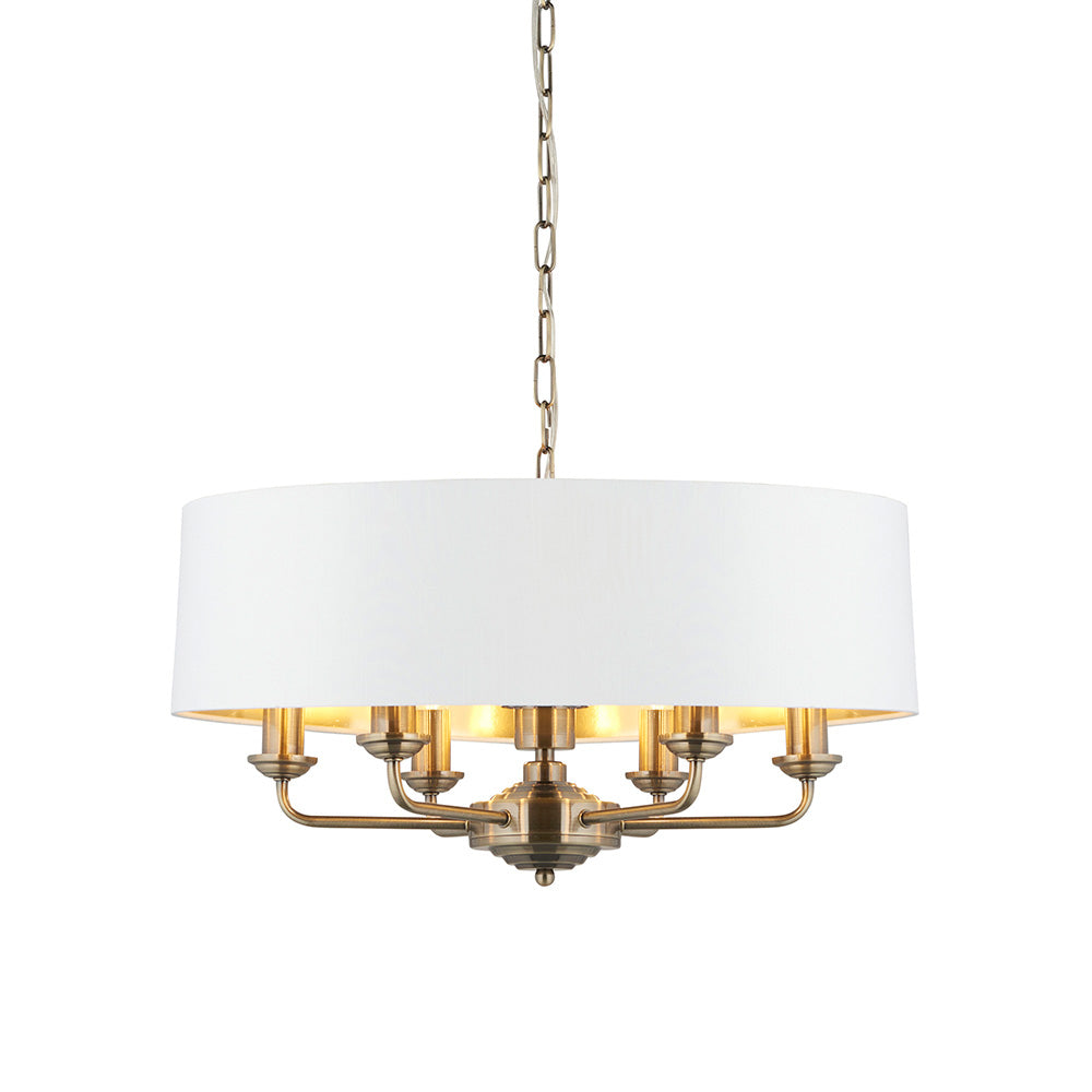Endon Brenley V1 6 light pendant with a wide white drum shade, gold-lined interior, antique brass multi-arm frame and suspension chain on a white background.