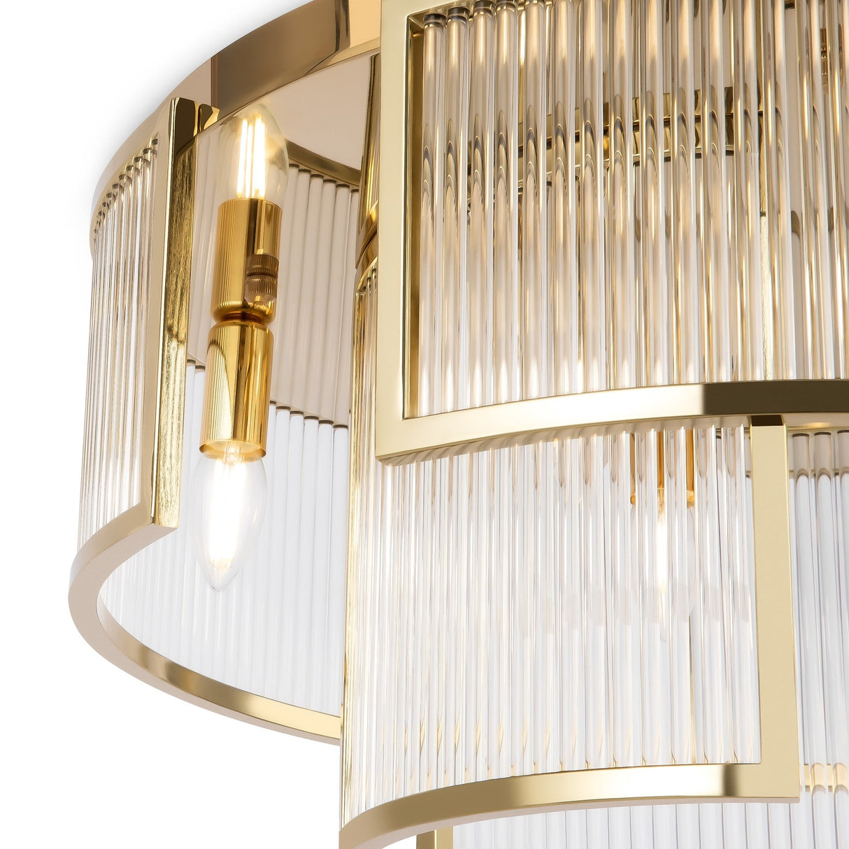 Close-up of the Frame 6 Light Flush - Gold, highlighting an elegant chandelier with a gleaming frame and clear glass rods. Two visible bulbs cast a warm glow, reflecting off the polished metal and embodying modern lighting elegance.