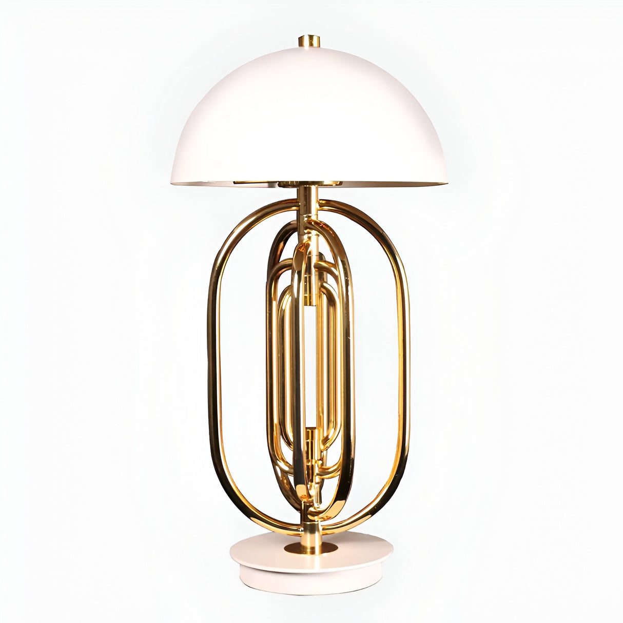 The Ascot 4 Light Large Table Lamp in white and gold features a modern Art Deco design with a dome-shaped white shade, a gold-finished metal base inspired by a tuba, and stands on a round white platform.