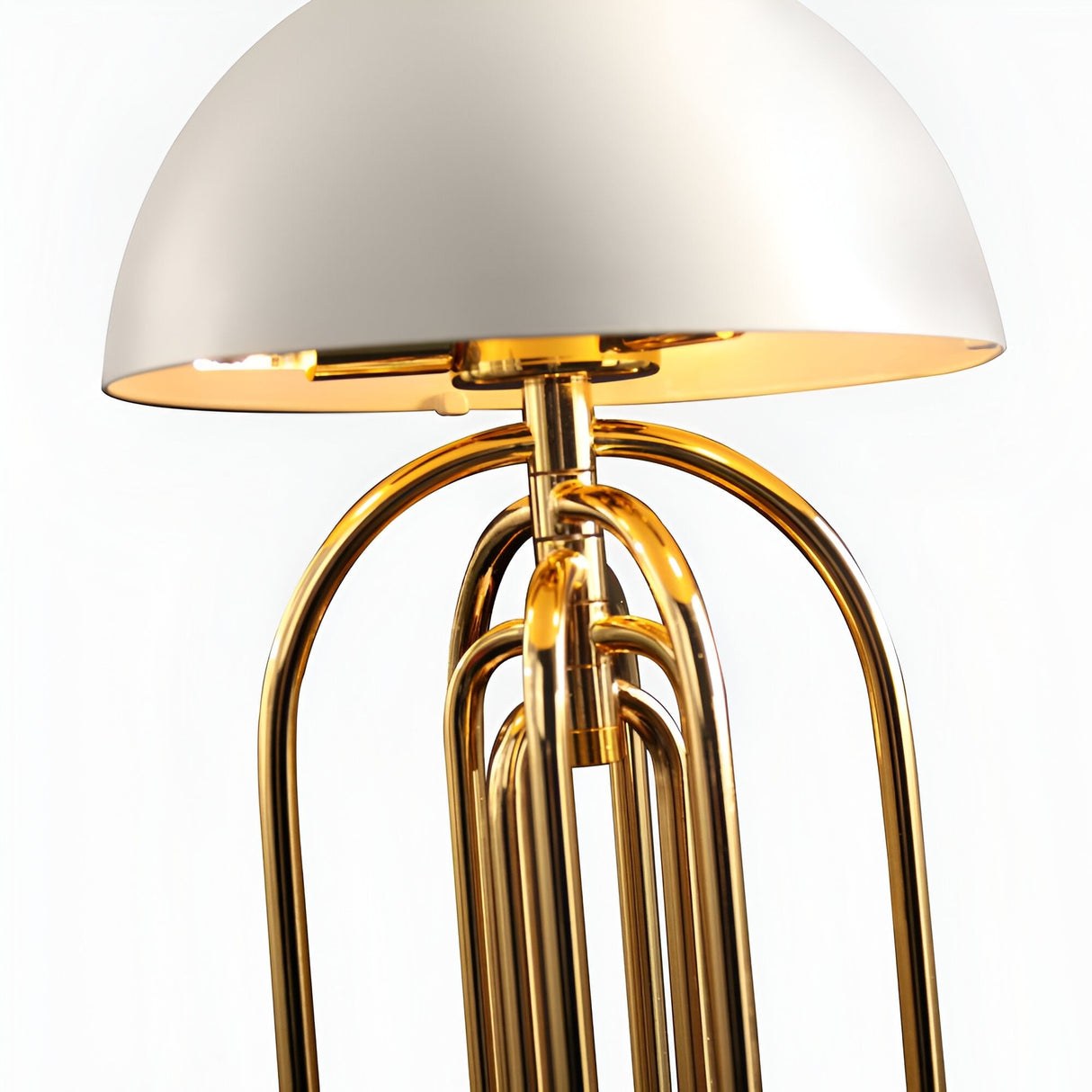 Close-up of the Ascot 4 Light Large Table Lamp in white and gold, featuring a dome-shaped shade and multiple adjustable gold-finished arcs, set against a plain white background.