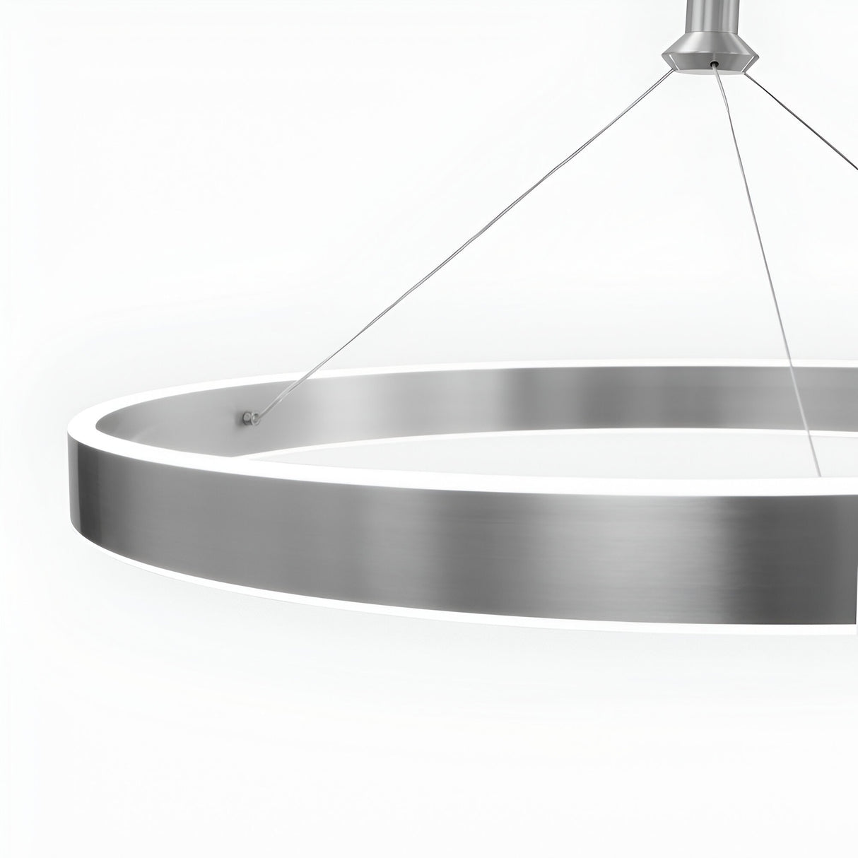 The Aurora LED Suspension Light - Matte Silver features a sleek, minimal design with a brushed finish, suspended by three thin cables. This modern pendant offers dimmable lighting for customizable ambiance against any backdrop.