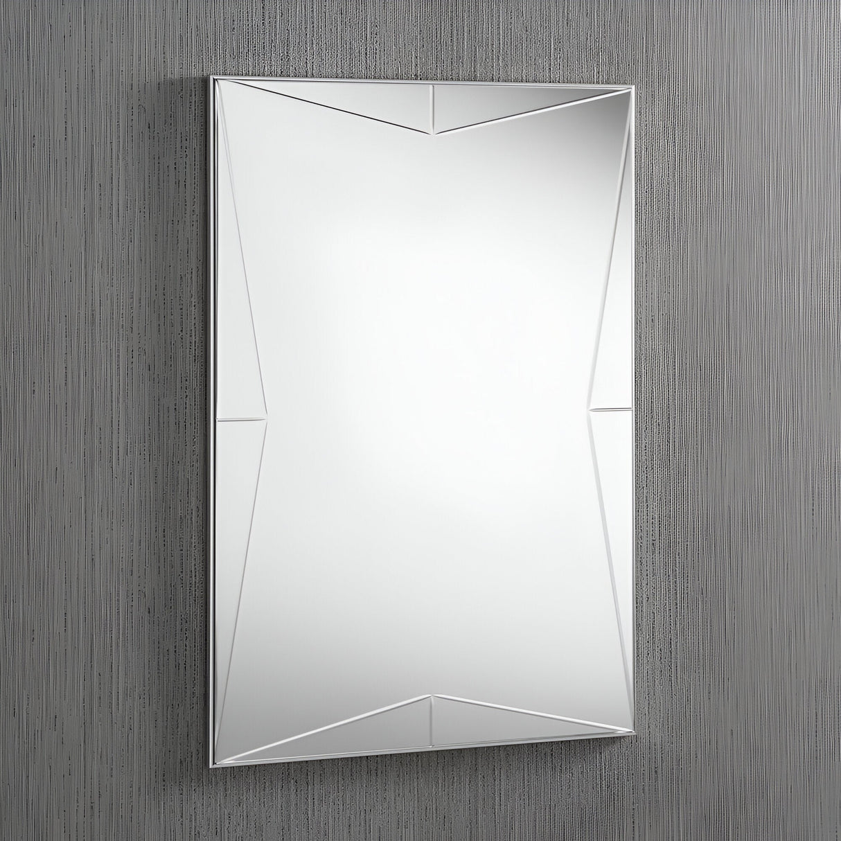 A Crystal Rectangle Wall Mirror - 92x62cm, featuring a sleek, minimalist silver frame, hangs on a textured gray wall. Its geometric design showcases triangular facets that add depth and visual interest.