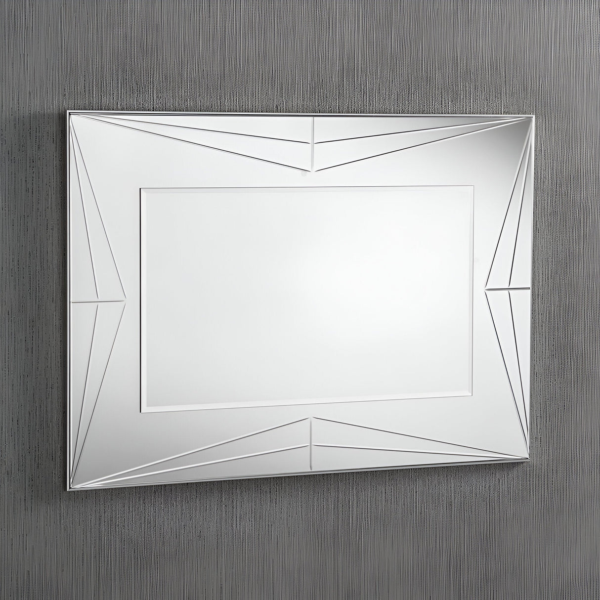The Polaris Rectangle Wall Mirror- 108x77cm, with its minimalist frame and angular patterns, mounted on a textured gray wall, brings a contemporary touch to any decor.