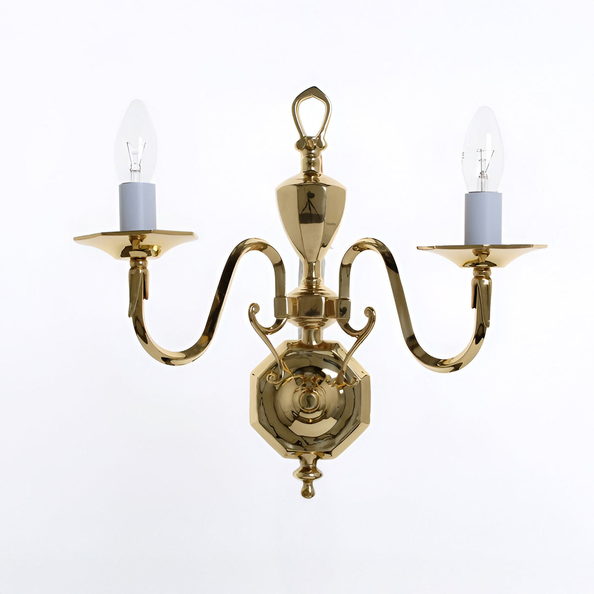 Impex Glenten 2-light traditional wall light in polished brass with twin curved arms, hexagonal backplate, urn finial and candle bulbs on a white background.