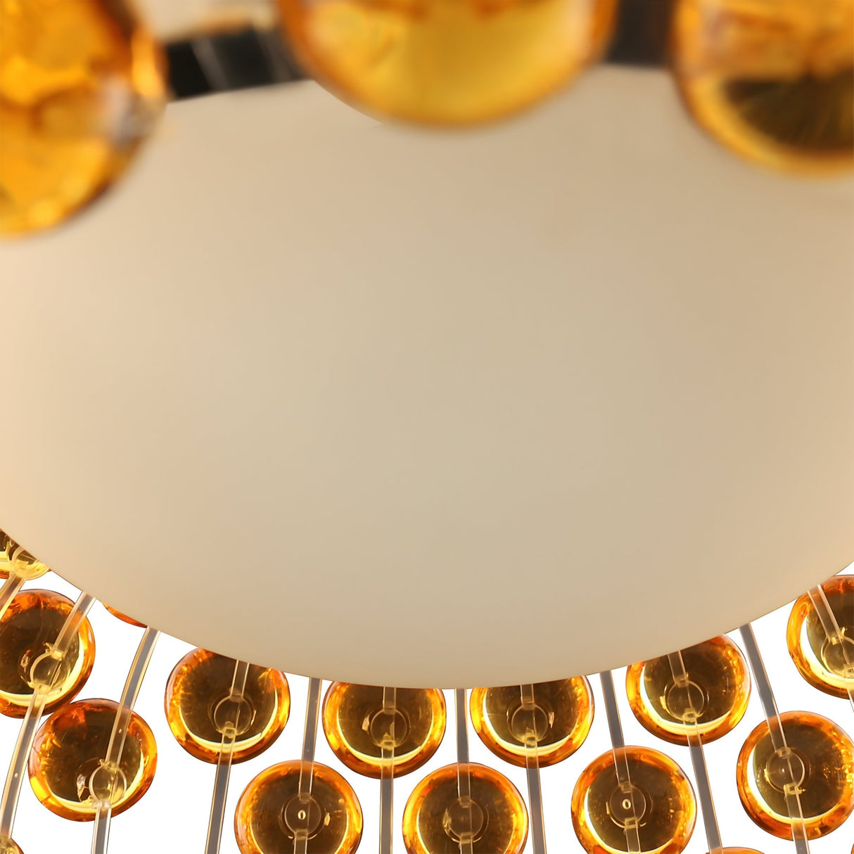 A close-up of the Briller LED Large Suspension Light - Gold features a round white center encircled by amber-toned acrylic spheres in a ring, showcasing modern decorative elegance.