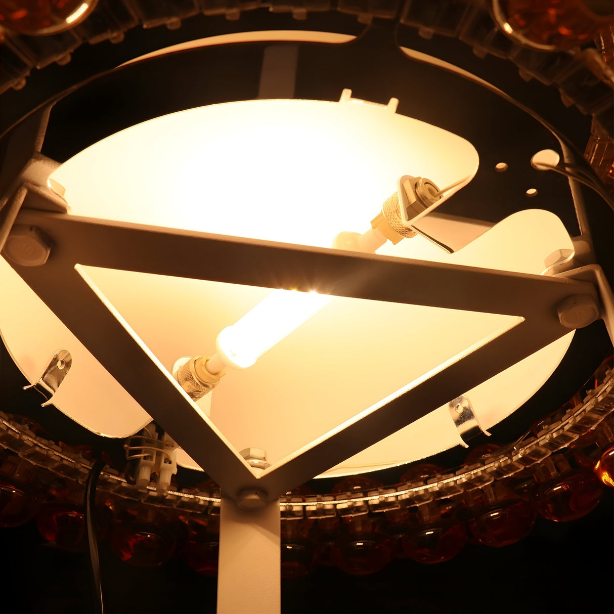 Close-up of the Briller LED Table Lamp - Gold, showing its bright, energy-efficient LED glow, geometric metal frame with white panels, and elegant gold finish from a low angle.