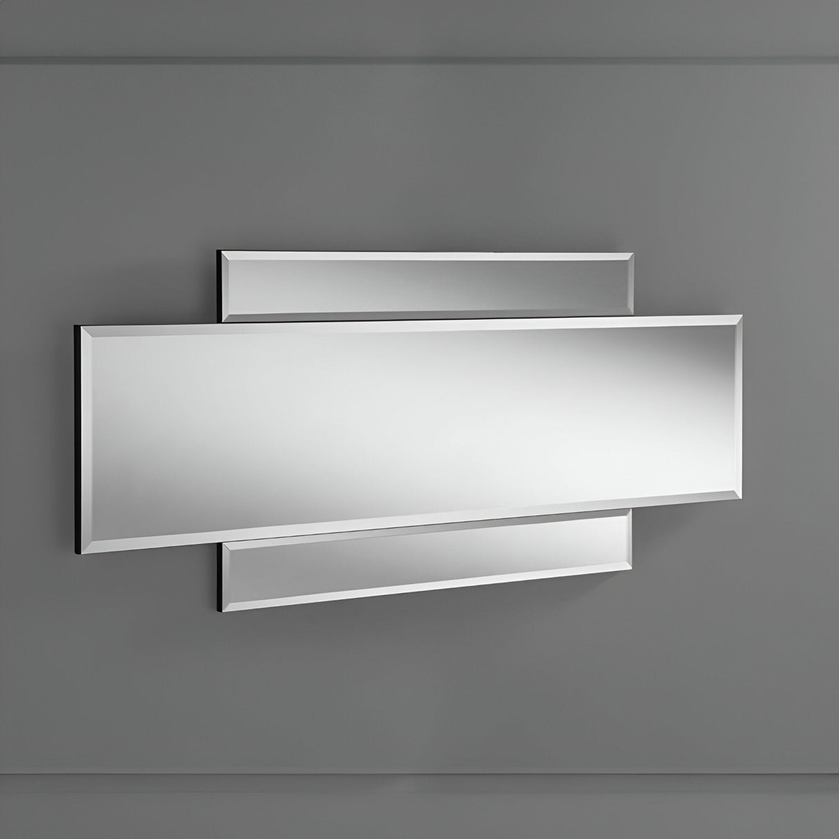The Imperia Panel Wall Mirror - 122x51cm, a modern home decor piece, showcases rectangular overlapping panels mounted on a gray wall. Its clean lines and minimalist design make this architectural element a sleek, reflective surface ideal for contemporary spaces.