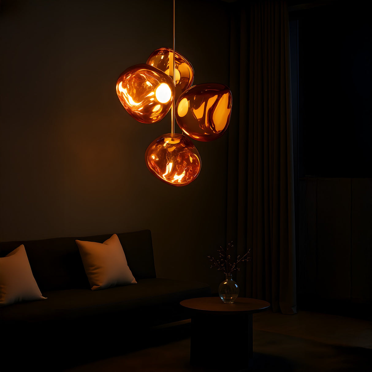 A modern living room boasts the Lava 4 Light LED Chandelier in copper above a round table with a glass vase. A dark sofa with white pillows sits by long curtains, adding inviting elegance to the space.