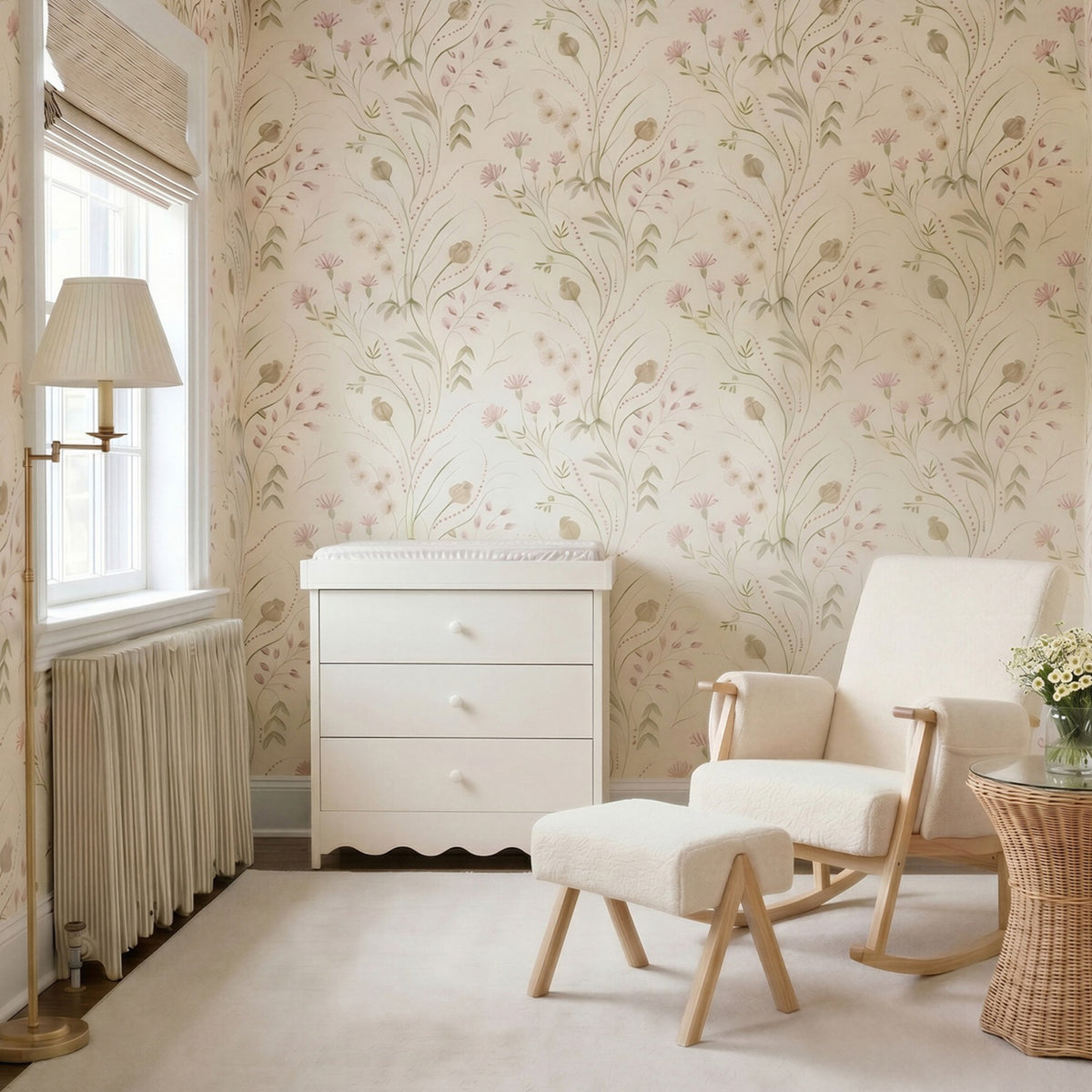 Dancer Changing Table with Drawers & Removable Top in cashmere, a cream MDF three-drawer dresser with scalloped base, shown in a nursery beside a cream armchair and floral wallpaper.