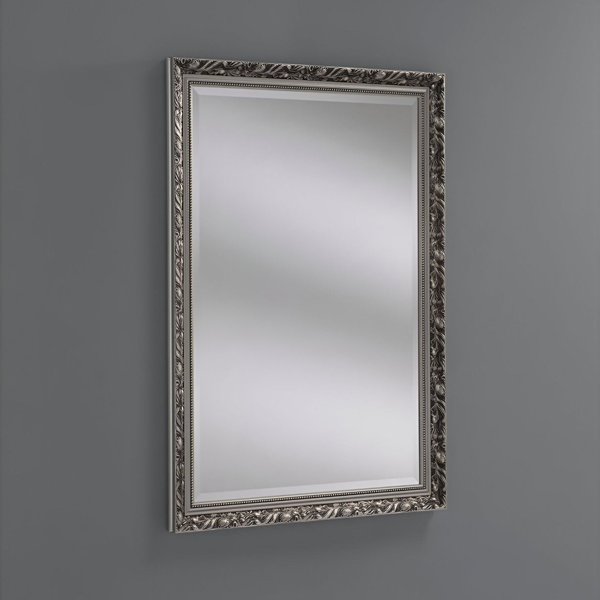 The Dahlia Rectangle Wall Mirror - Silver enhances a gray wall with its classic elegance, showcasing an ornate silver frame adorned with intricate floral patterns and a luxurious silver finish for an elegant touch.