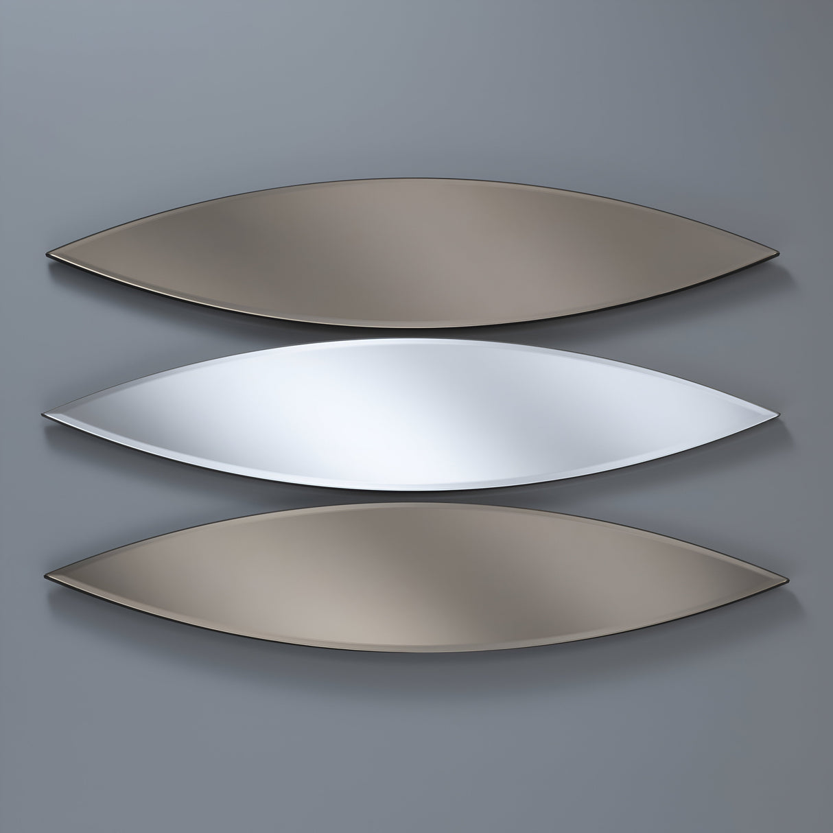 The Velouria Oval Wall Mirror Bronze & Silver Set features three metallic leaf-shaped mirrors mounted horizontally on a gray wall. The middle mirror is silver, and the others are darker gray, spaced evenly to create a modern abstract design that enhances home decor.