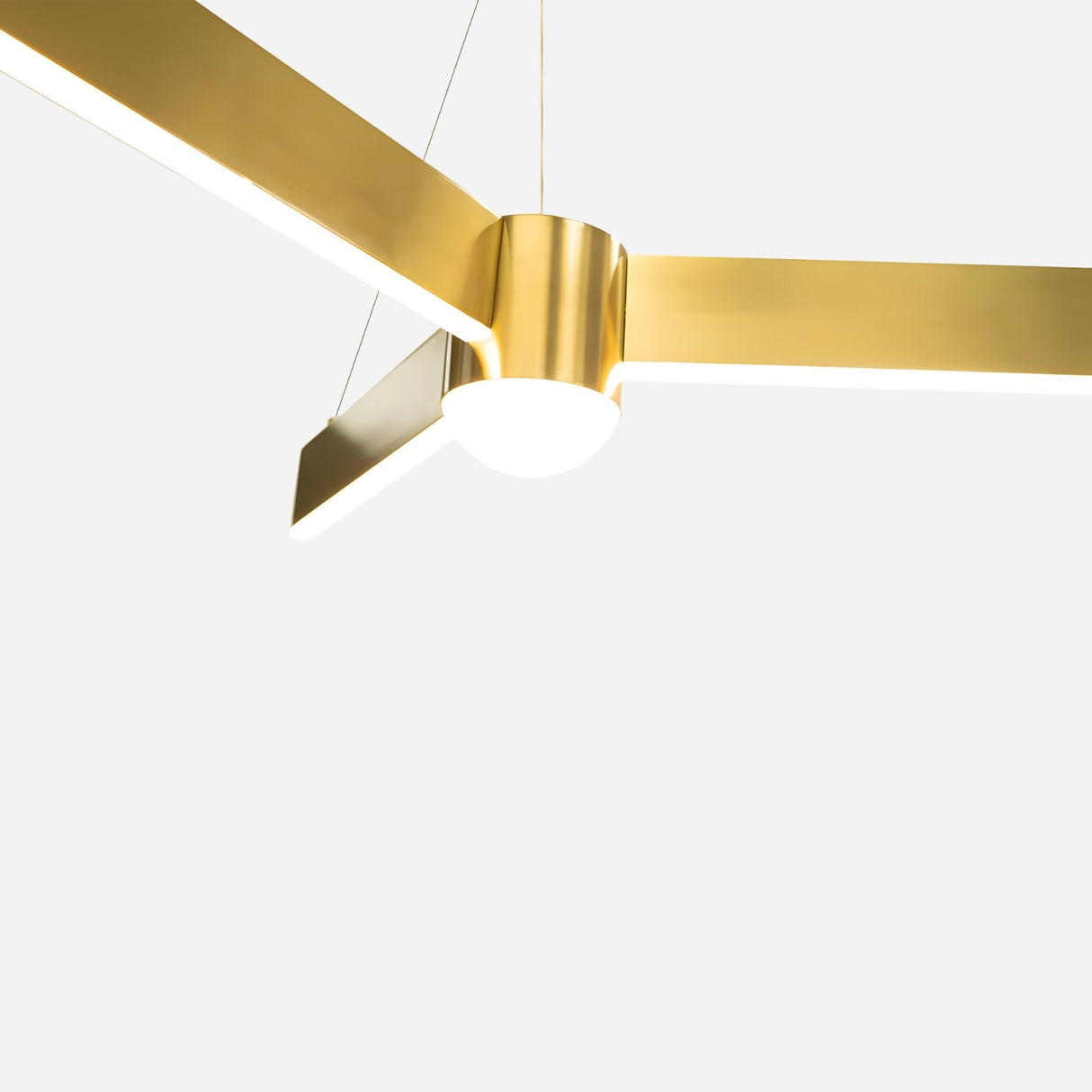 Fritz LED Suspension Light - Matte Gold features three horizontal arms and a central cylindrical hub, suspended by wires against a plain white background, offering advanced LED technology for efficient illumination.
