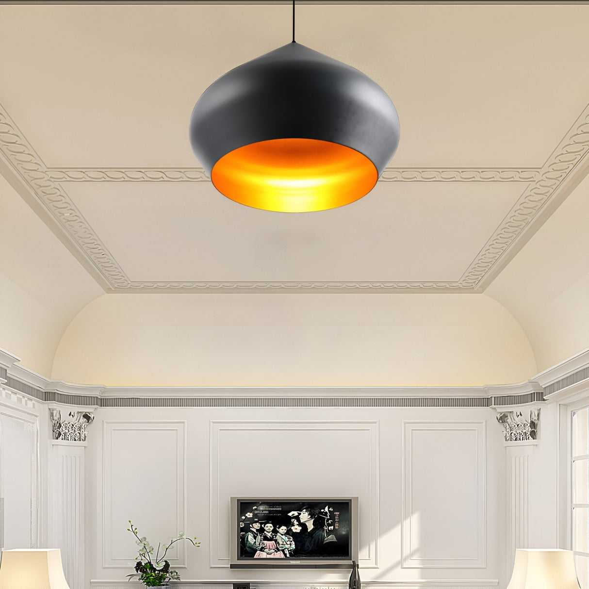 The Funk Stout Small Pendant Light - Black, with a gold interior, adds compact elegance to a white living room featuring classic molding, two lamps, a plant, and a flat-screen TV on the far wall.