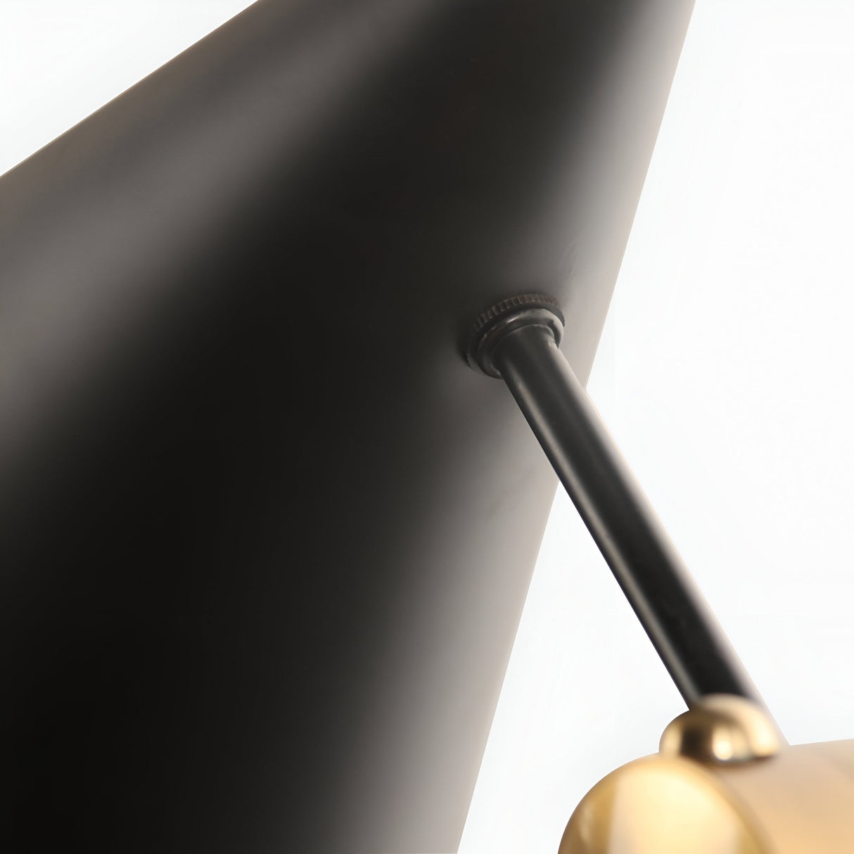 Close-up of the Funk Table Lamp - Black, featuring a black metal adjustable shade and brass-accented arm, set against a white background—perfect for modern interiors.