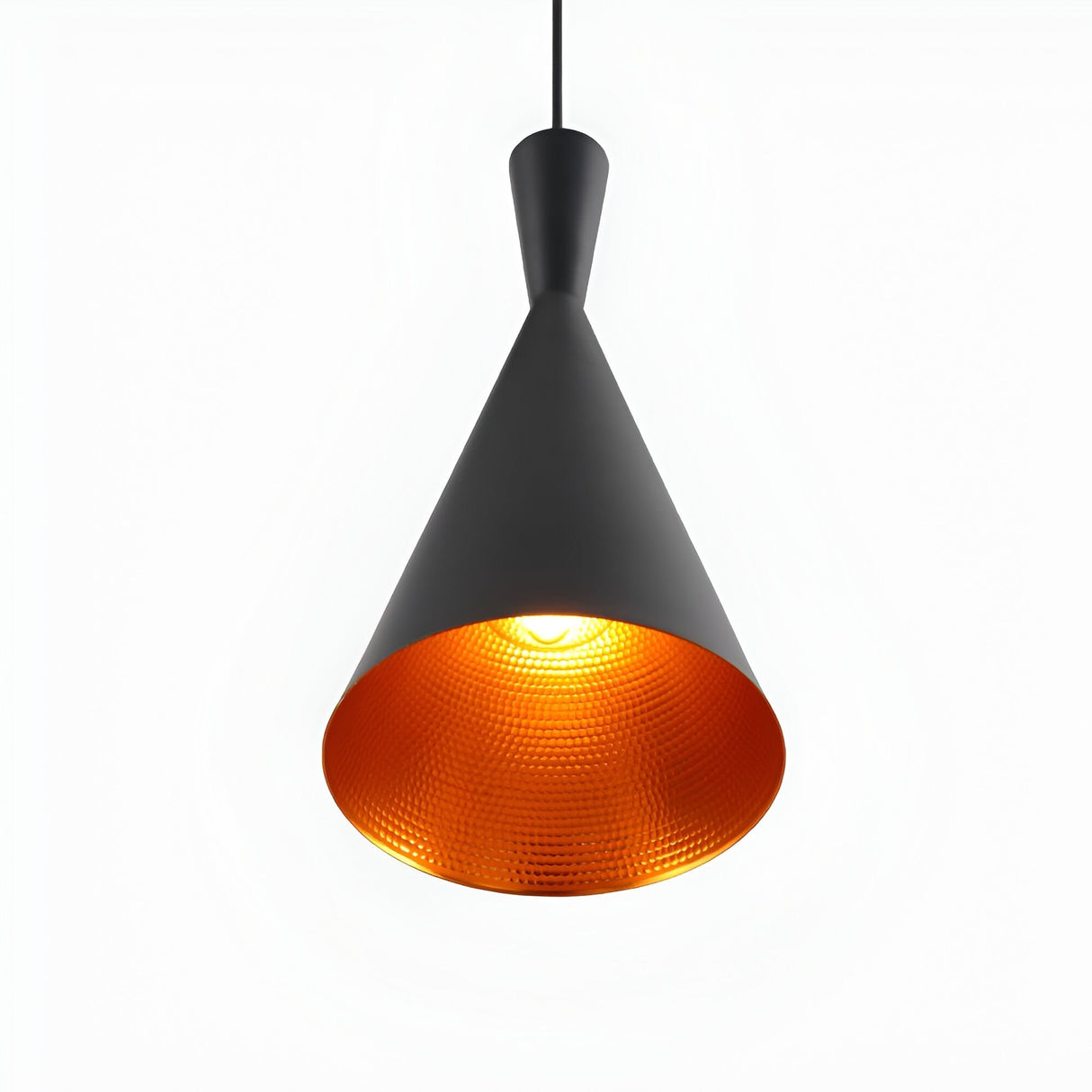 The Funk Tall Pendant Light - Black features a modern, matte black metal cone design with an orange-gold textured interior, suspended by a black cord and glowing warmly against a plain white background.