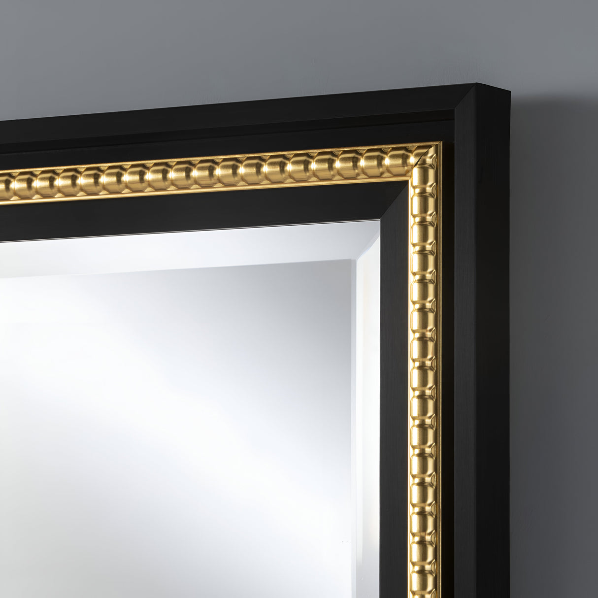 Rectangular wall mirror with a bold black frame accented by an ornate gold trim, exuding luxury and timeless style, ideal for upscale living rooms or hallways.