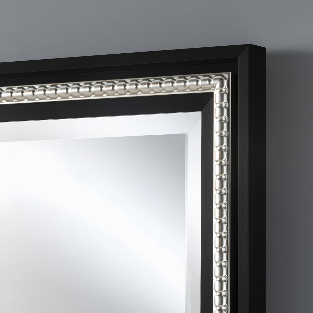 Rectangular wall mirror with a sleek black frame enhanced by a polished silver trim, offering a refined and contemporary design suitable for modern spaces.