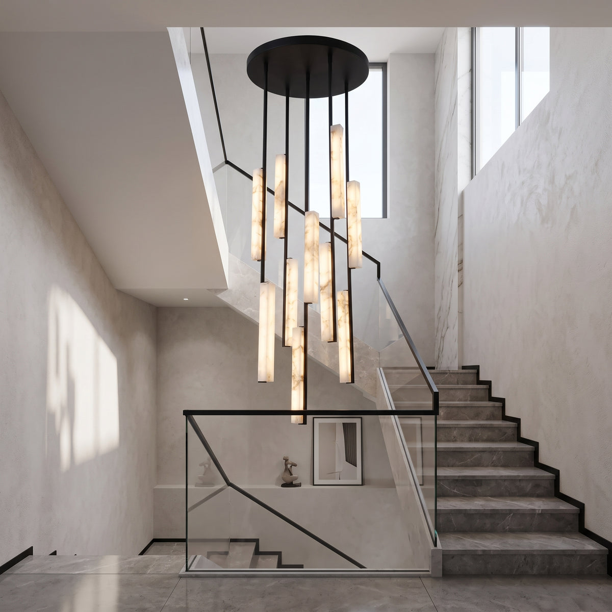 Selvara 10 Light Alabaster Cluster Chandelier in Matt Black, staggered vertical alabaster bars suspended from a round black canopy above a marble staircase.