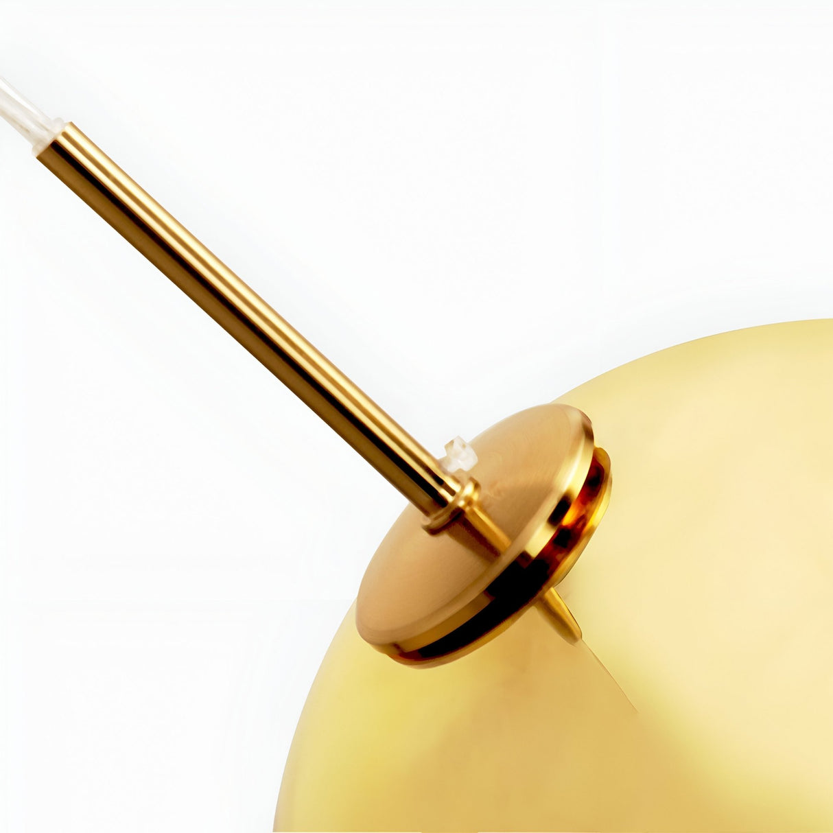 Close-up of the Grand Ball Glass Pendant 25cm in Gold, featuring a round base, slender angled rod, and reflective metallic finish. This modern pendant light includes energy-efficient LED lighting and is set against a white background.
