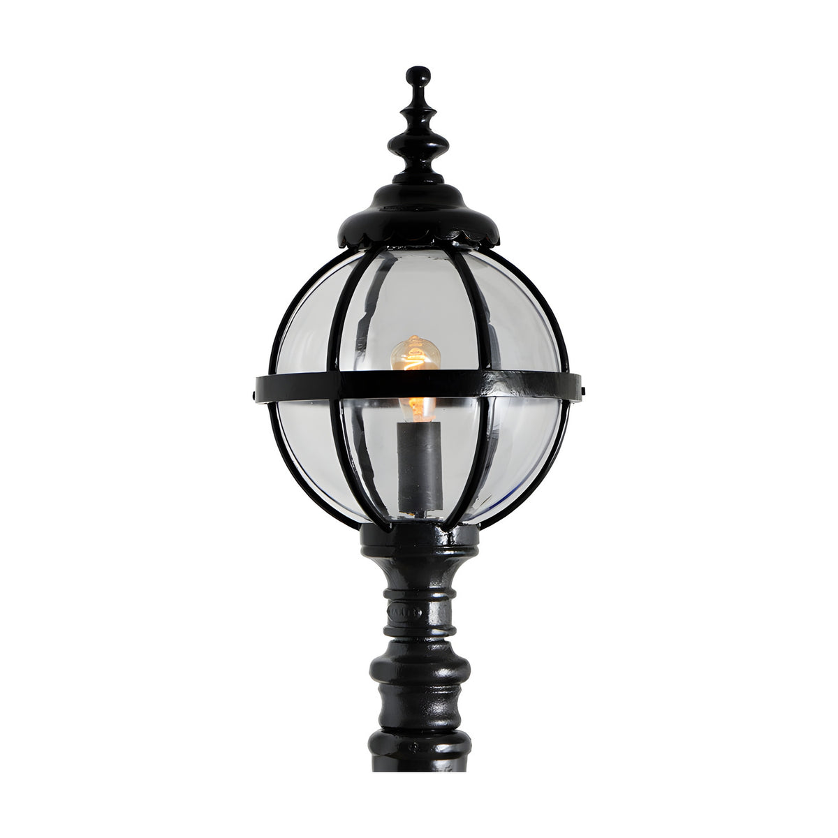 Victorian Manor cast iron globe pedestal post light in black, with a banded cage globe shade, ornate cap and finial, and a decorative column base, shown lit against a plain white background.