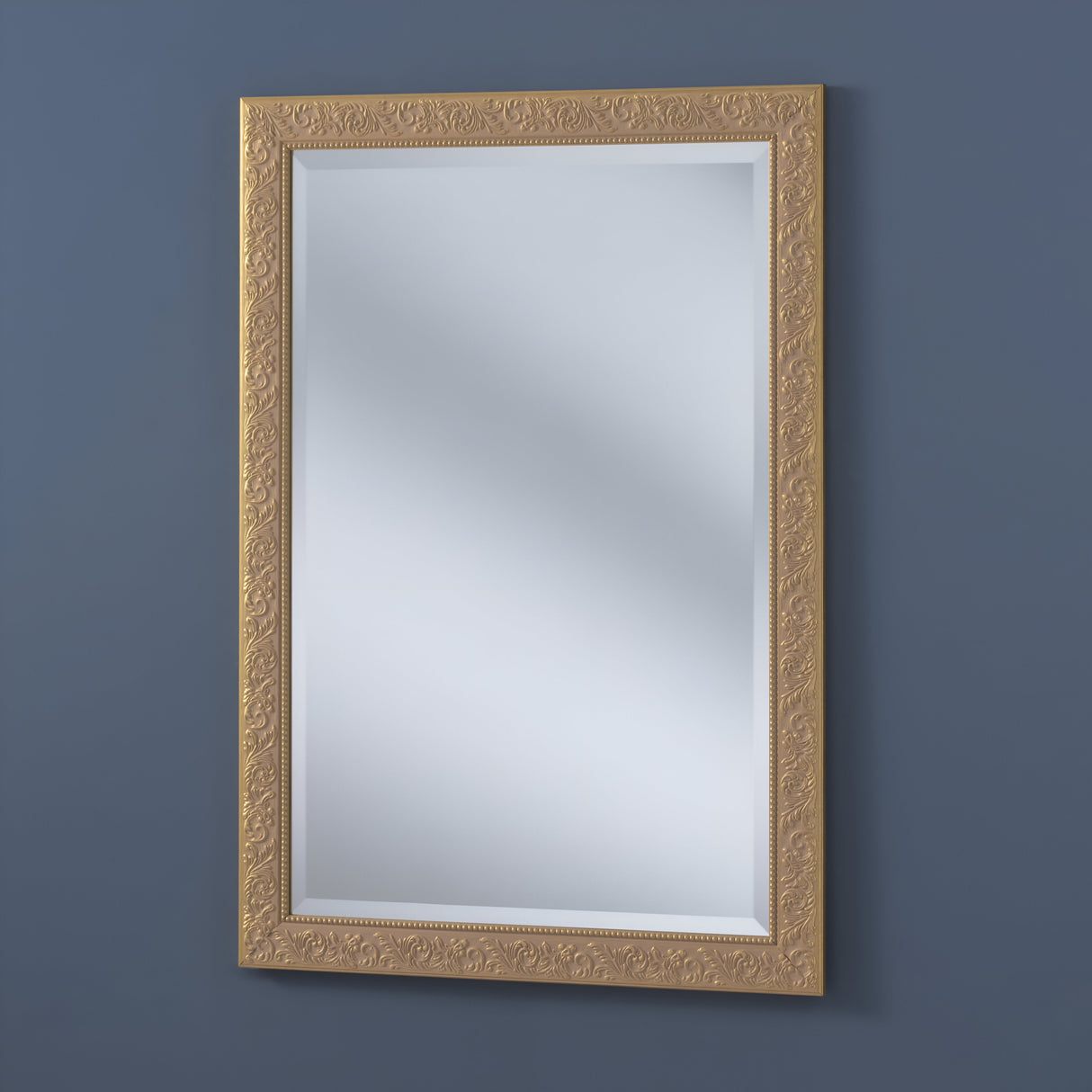 The Perleon Rectangle Wall Mirror - Gold features an ornate frame and is elegantly showcased on a dark blue wall.