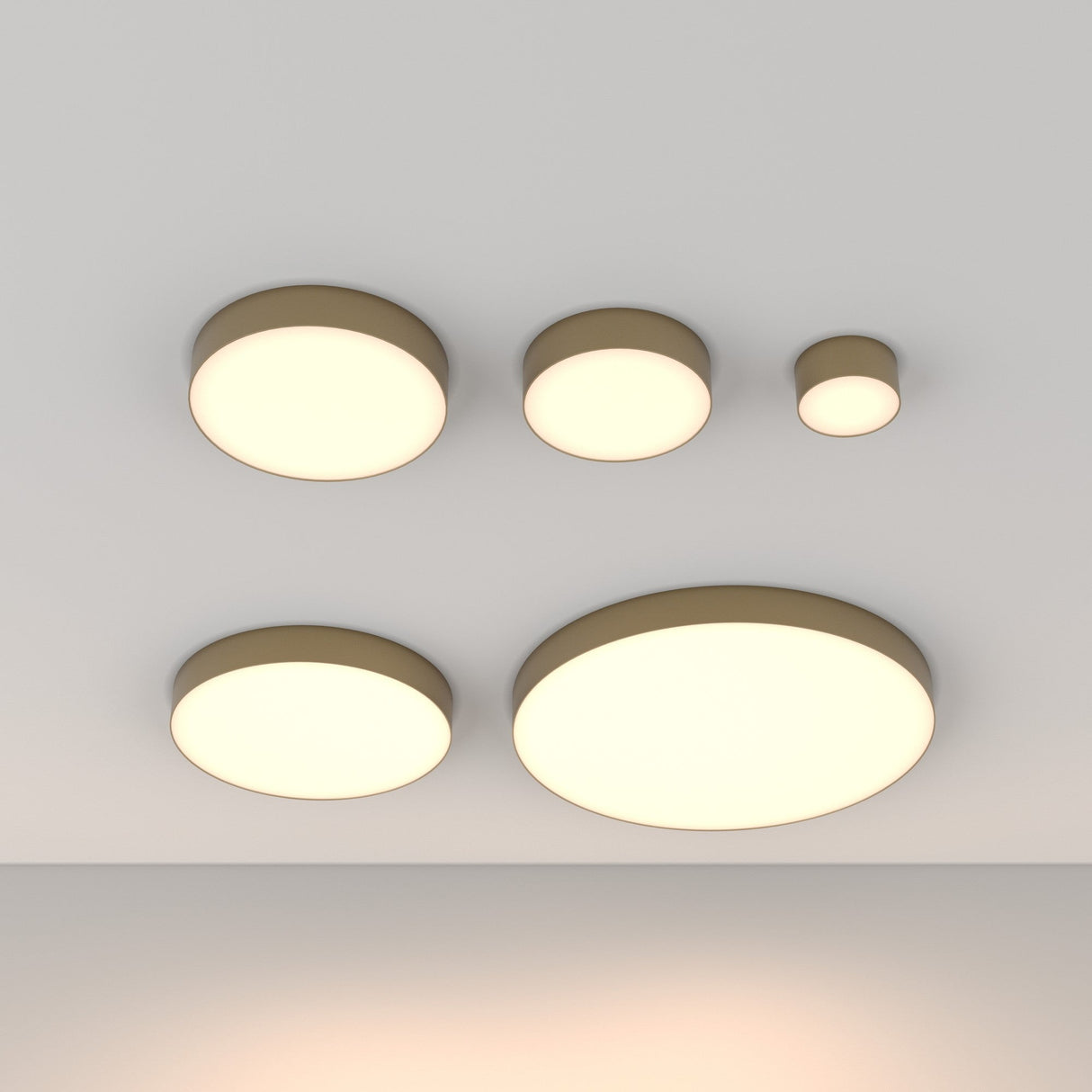 The ceiling is adorned with five Zon LED Flush Ceiling Lights, each modern and circular in design with varying sizes. These 24W lights emit a warm 3000K glow and feature energy-efficient lighting, a minimalistic style, and matte gold outer rims, all evenly spaced across the white surface.