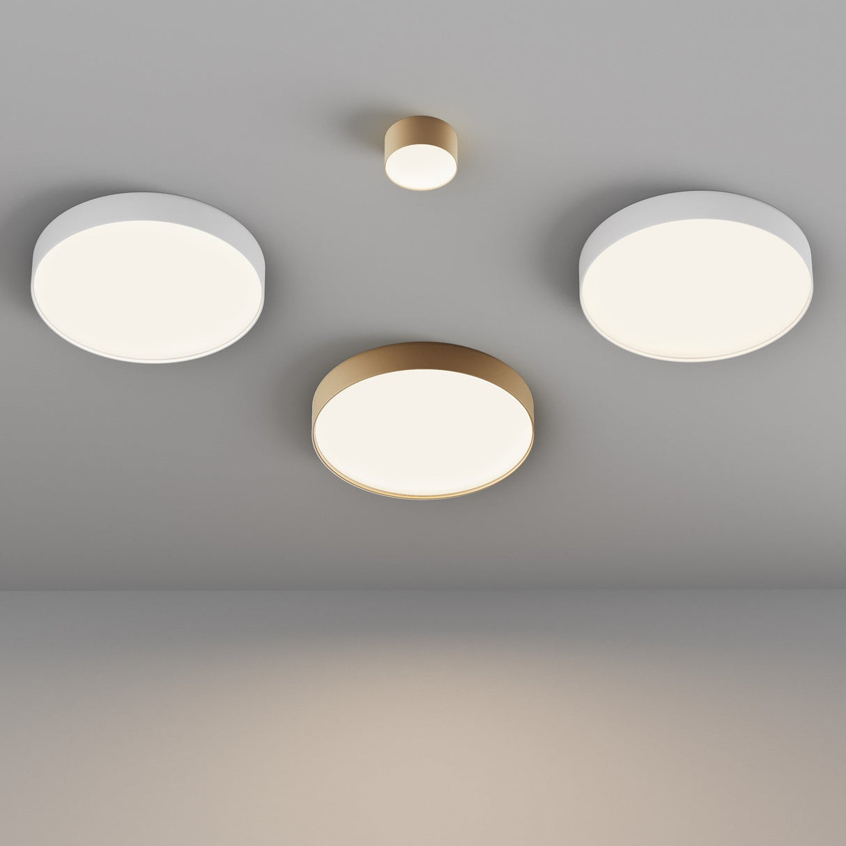 The ceiling features a sleek setup with three Zon LED Medium Flush Ceiling Lights in white and a smaller gold-cased light at the center, creating a minimalist and modern ambiance.