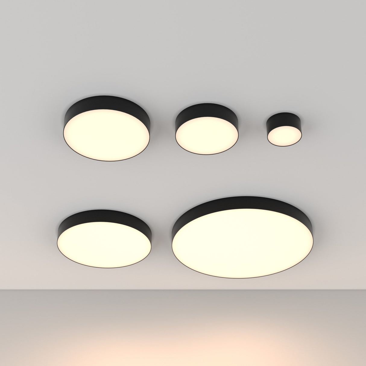 Five large, round Zon LED Large Flush Ceiling Lights (3000K, 90W) with black rims cast an ambient glow on the white ceiling. Arranged in two rows, they embody modern interiors with their minimalist design.