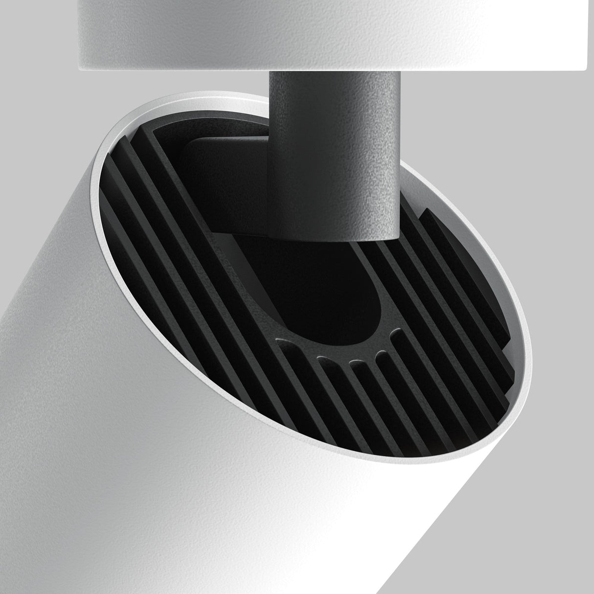 Close-up of the Focus Zoom LED Single Surface-Mounted Spotlight, 12W, featuring a modern cylindrical design with a white outer shell and black ribbed interior. The fixtures adjustable beam angle highlights its sleek minimalism against a light gray background.