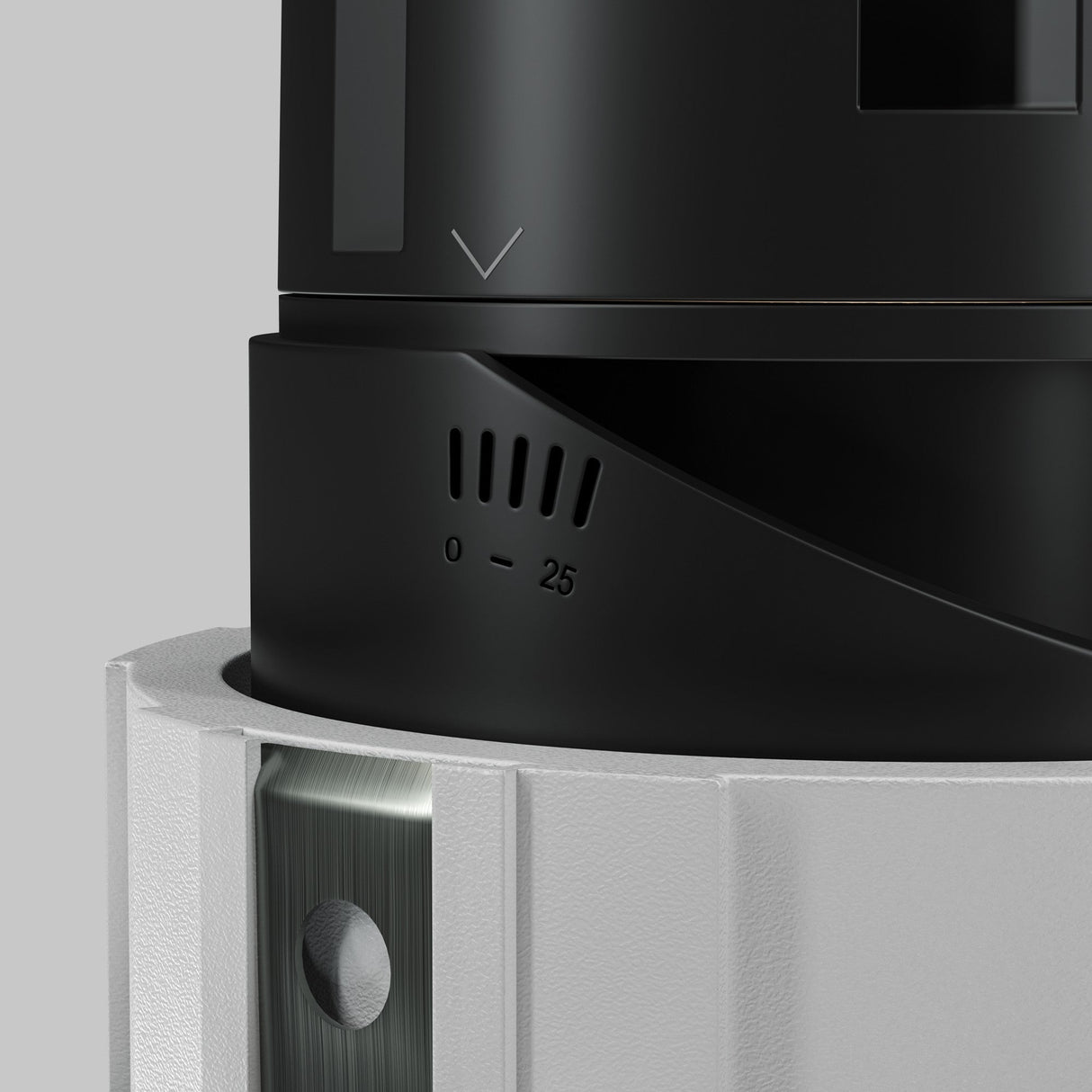 Close-up of a black and white cylindrical device with high-quality construction, featuring a rotating dial numbered 0 to 25, mounted on gray, akin to the precision of the Wise LED Round Recessed Downlight 7W 3000K - White.