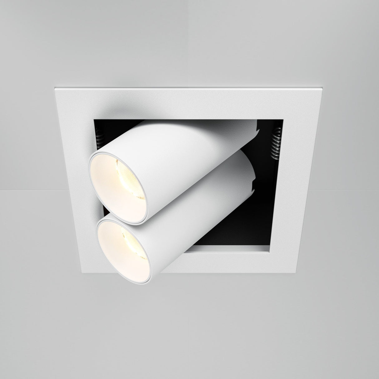 The Magnum LED Recessed Twin Adjustable Downlight 14W 3000K - White, is a square fixture with dual adjustable heads and energy-efficient LEDs, designed to emit a bright glow downward. Its modern and minimalistic style blends effortlessly into a white ceiling.