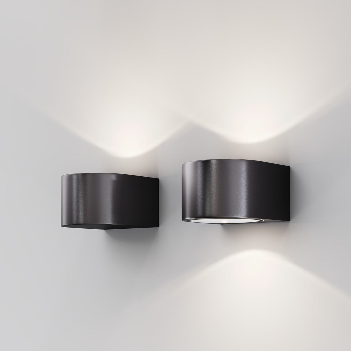 The Blow Outdoor LED Up and Down Wall Light - Graphite provides sleek, modern lighting with soft white illumination both upward and downward against a light gray background. Its design is stylish with a sturdy IP54 durability rating.