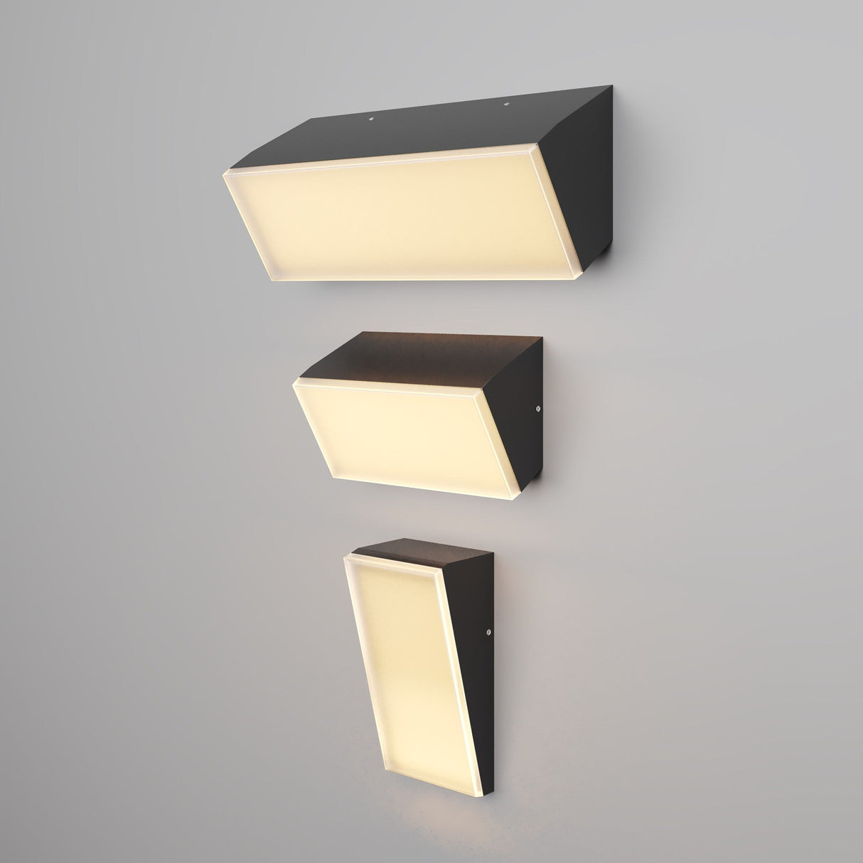 Three Brick Outdoor LED Wall Lights - Graphite (O436WL-L10GF3K1) with modern triangular frames, LED-illuminated against a plain gray background. These geometric lights vary in size, arranged vertically, with the largest at the top and smallest at the bottom.