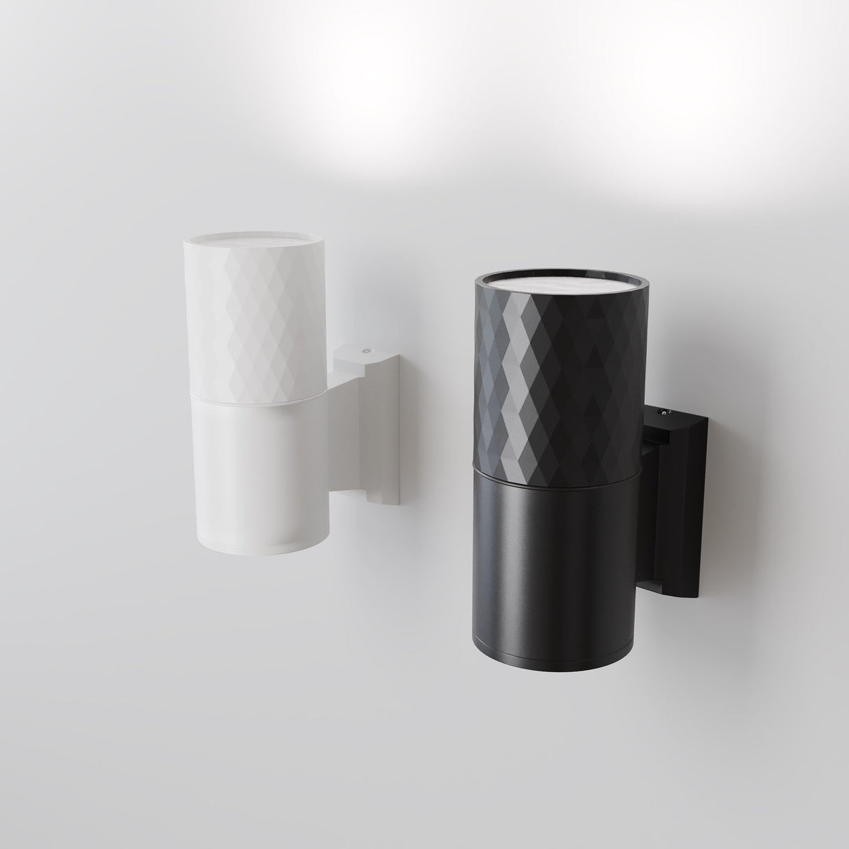 The Bowery Outdoor 1 Light Wall Light in white (O583WL-02W) is a modern cylindrical fixture, crafted from durable metal with a diamond texture. It adds a contemporary touch and softly illuminates walls, complementing another black variant against a plain white backdrop.