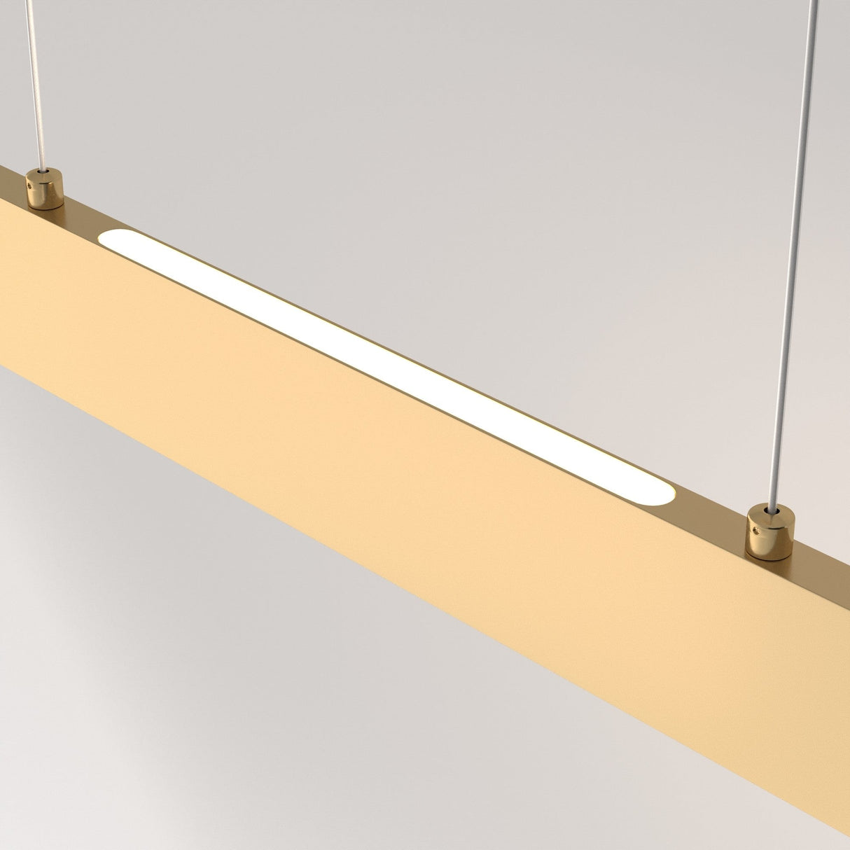 The Step LED Linear Suspension Light 4000K 30W features a modern, minimalist design with a slim rectangular shape. It hangs from two thin wires, offering energy-efficient illumination with a warm gold finish and central white light strip against a neutral gray background.