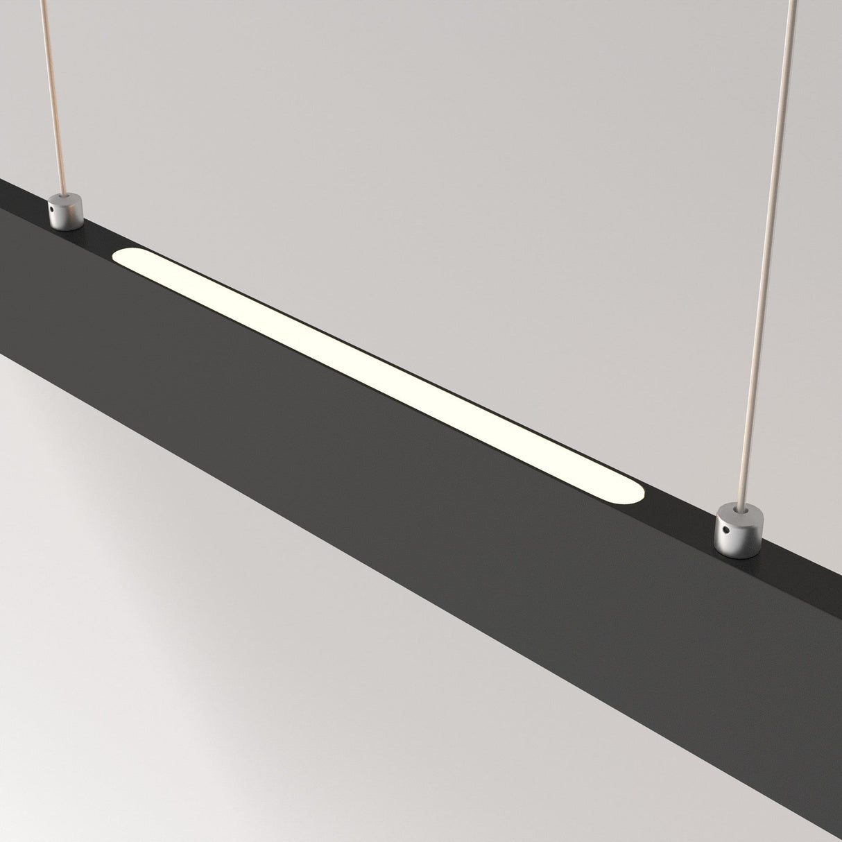 The Step LED Long Linear Suspension Light 4000K 30W - Black is a sleek, modern fixture featuring a slim black rectangular design with a glowing white strip. Suspended by two thin cables, it utilizes advanced SMD LED technology for vibrant illumination in minimalistic setups.