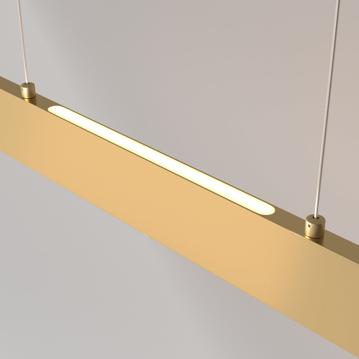 The Step LED Long Linear Suspension Light 3000K 30W - Gold features a sleek rectangular design and hangs by two thin cables. With energy-efficient SMD LEDs, it casts a soft white glow, enhancing its contemporary look against a neutral gray background.