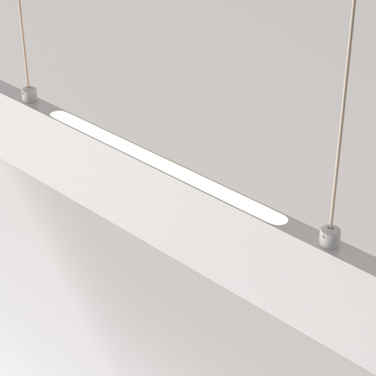 Close-up of the sleek Step LED Long Linear Suspension Light 4000K 30W - White, suspended by two thin cables. The rectangular panel uses SMD LED technology to emit a soft, even glow against a plain light-colored background.
