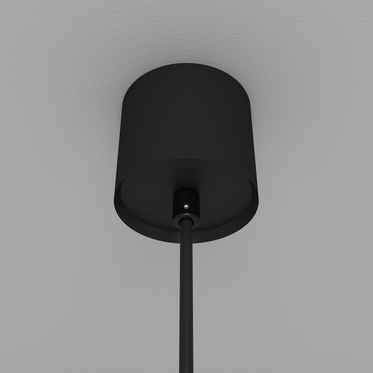 The Luna LED Globe Pendant Light 10cm 3000K - Black & White elegantly contrasts against a white ceiling with its sleek black cylindrical design and energy-efficient lighting, embodying modern elegance.