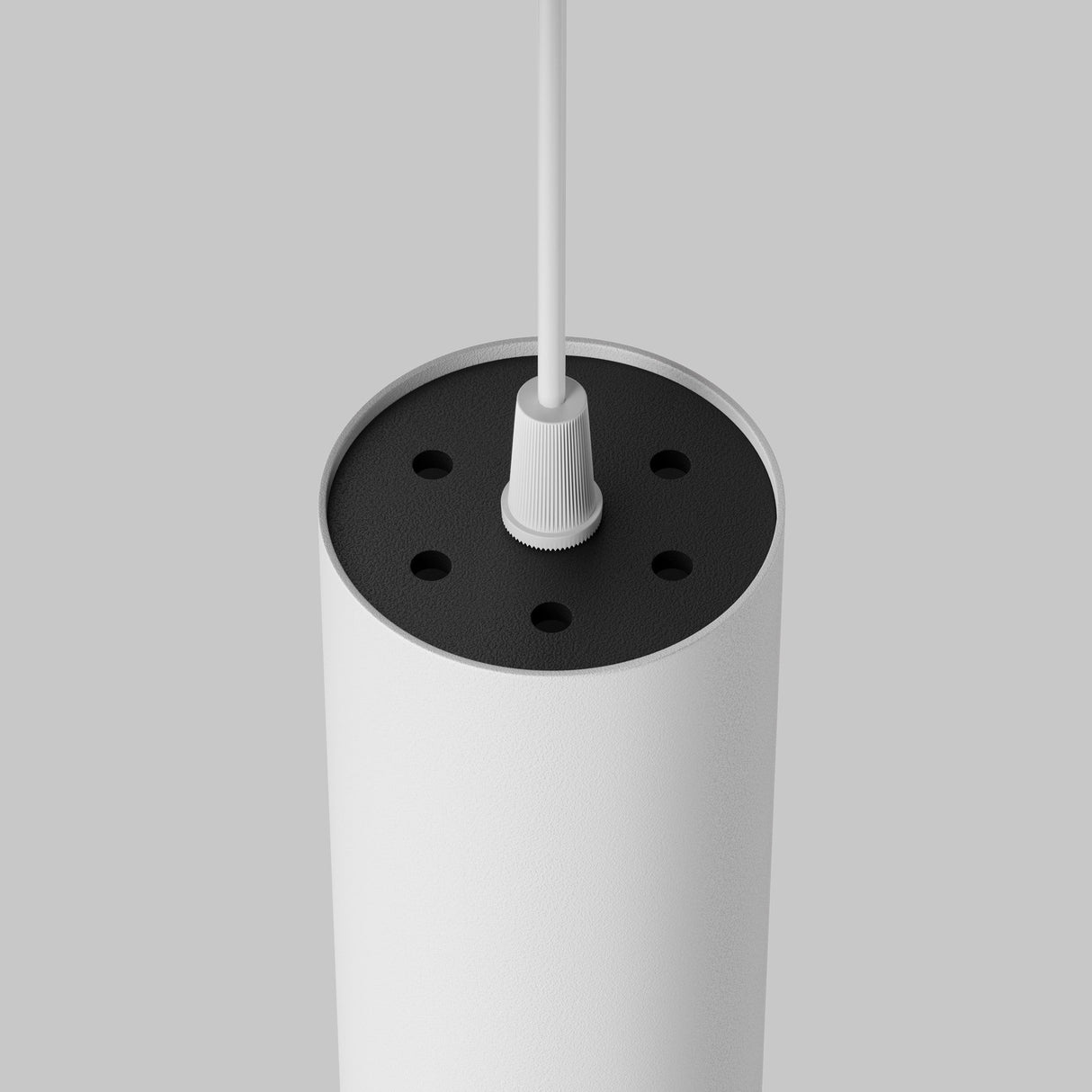 The Focus LED Pendant Light 3000K - White features a modern minimalist design with a cylindrical white body, sleek black top, and white cord. Perfect against a light gray background, it seamlessly complements contemporary spaces.