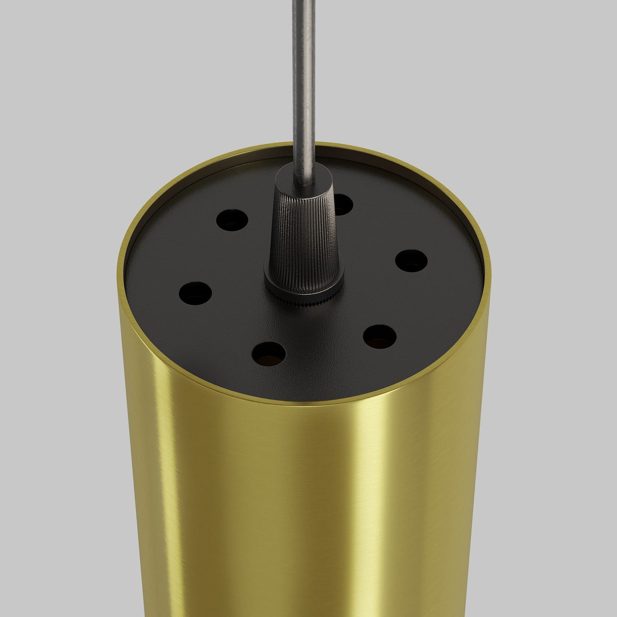 Close-up of the Focus LED Pendant Light 3000K in a brass finish with a black top, featuring multiple small circular holes and a central cord attachment. The gold cylindrical design contrasts with the light gray background.