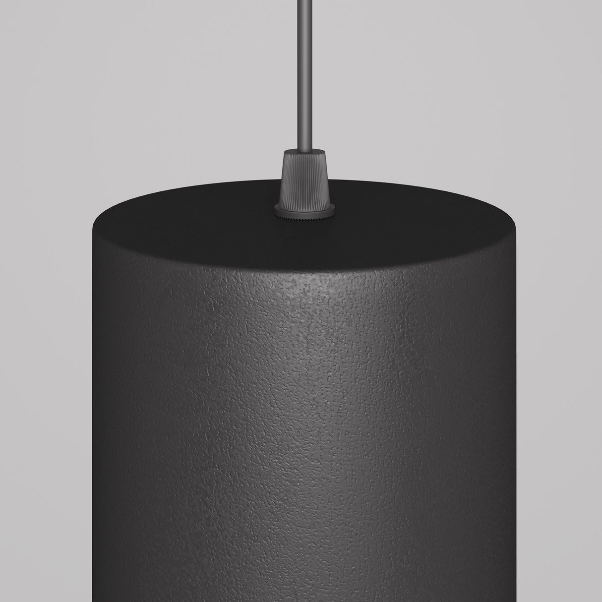 The Orlo LED Pendant Light 3000K in Black showcases a sleek, cylindrical design with an integrated LED. It hangs elegantly from an adjustable cord against a plain gray background, making it perfect for any modern space.