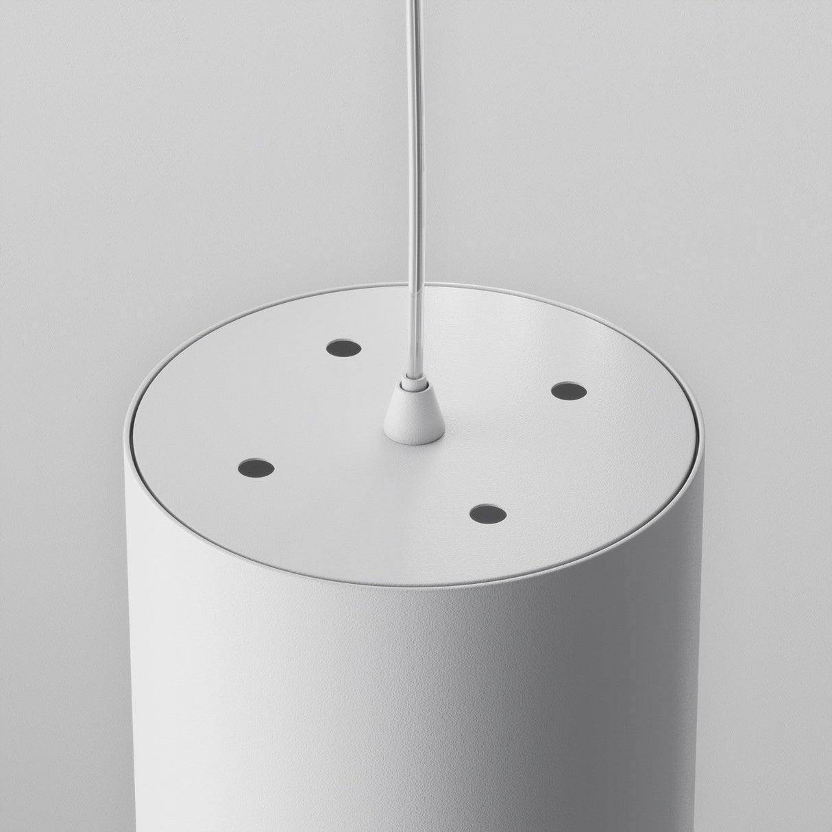 A close-up of the Polar Short Round Pendant Light - White shows its sleek cylindrical design. The thin center cable is encircled by four evenly spaced black dots, seamlessly integrating into modern interiors against a plain light gray backdrop, enhancing its minimalist aesthetic.