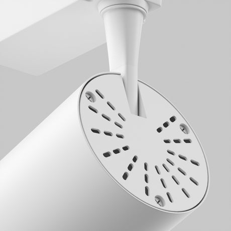 Close-up of the Vuoro S LED 6W spotlight in white, showcasing its cylindrical design with a perforated front panel and adjustable swivel mechanism, attached to an angled support against a light gray background for a sleek, minimalist aesthetic.